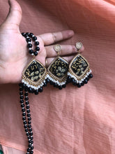 Handmade black floral resin jhumka earrings with matching beaded necklace set.