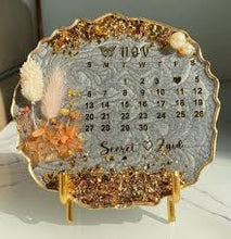 Handmade floral resin calendar tray with two-colour design.
