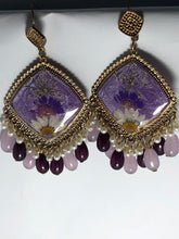 Handmade floral resin jhumka earrings with matching bead drops and a glossy resin finish.