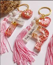 Floral resin keychain set with gold name customization.