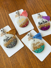 Handmade glitter resin keychains in four colours, personalized with custom names.