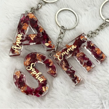 Resin initial keychain with real dried rose petals and gold flakes.