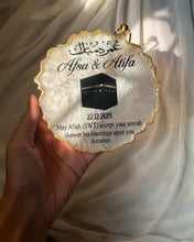 Personalized resin decorative piece commemorating Umrah pilgrimage with two-colour design.